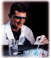 A student performs double-replacement reactions in a microplate.